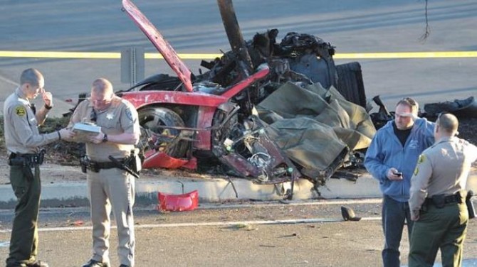 Sheriff deputies work near the wreckage of a Porsche sports car that crashed into a light pole on Hercules Street near Kelly Johnson Parkway in Valencia on Saturday, Nov. 30, 2013. A publicist for actor Paul Walker says the star of the "Fast & Furious" movie series has died in a car crash north of Los Angeles. He was 40. Ame Van Iden says Walker died Saturday afternoon. No further details were released. (AP Photo/The Santa Clarita Valley Signal, Dan Watson)